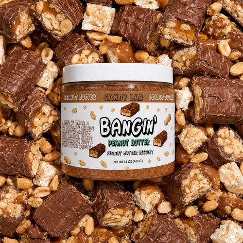 Candy Bar dessert peanut butter jar surrounded by chocolate, roasted peanuts and caramel-inspired mix-ins.